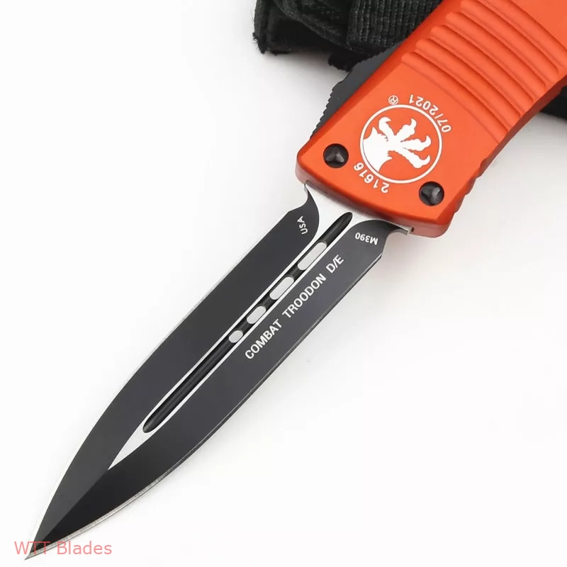MT Combat Troodon D/E OTF Automatic Knife Orange (3.8" Black) (2) MT Combat Troodon D/E OTF Automatic Knife Orange (3.8" Black) (2)